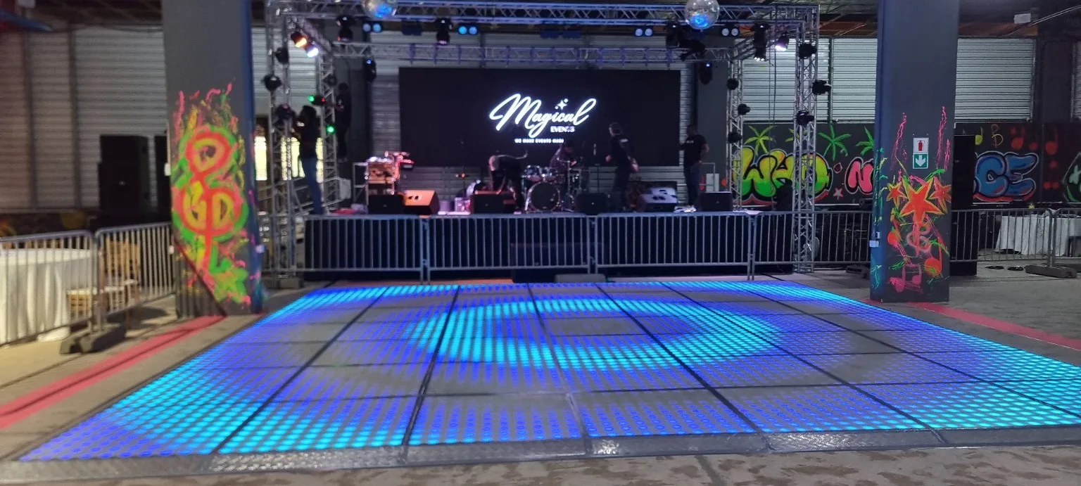 Large blue LED dance floor in front of a trussed stage